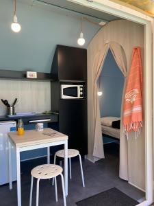 a kitchen with a table and chairs and a tent at Camping Club l'Air Marin in Vias