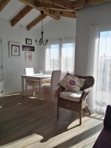 a dining room with a table and a chair at Sol del Este in Es Castell
