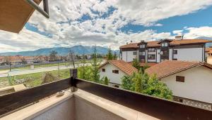 a view from the balcony of a house with mountains at Hotel FAMIL - adults only in Bansko +85 photos