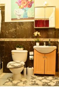 a bathroom with a toilet and a sink at Caribbean estate deluxe 2 in Portmore +43 photos