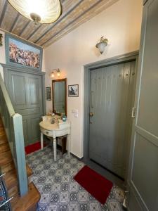 a bathroom with a sink and a mirror at Arachova Boka's House, Elegant Apartment in Arachova