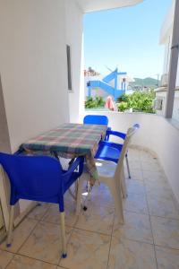a table and chairs sitting on a balcony at Vila Xhafa in Ksamil