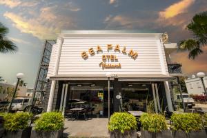 a restaurant with a sign on the front of it at Sea Palm Otel Yalıkavak in Yalıkavak
