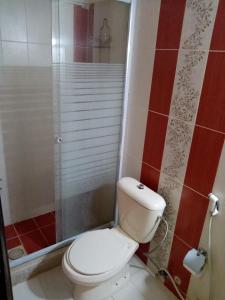 a bathroom with a white toilet and a shower at الفارس الوسيم للشقق الفندقيه in Amman