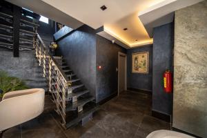 a hallway with a staircase in a house at Sea Palm Otel Yalıkavak in Yalıkavak