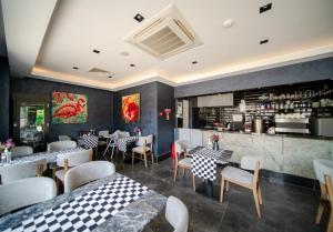 a restaurant with tables and chairs and a bar at Sea Palm Otel Yalıkavak in Yalıkavak