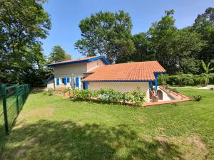 a house with an orange roof in a yard at La Clairière du Seignanx in Saint-Martin-de-Seignanx +26 photos
