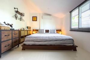 a bedroom with a bed and a dresser and a window at Pool Villa Bangrak, 2 mins to beach!!!! in Koh Samui  +19 photos
