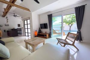 a living room with a couch and a table at Pool Villa Bangrak, 2 mins to beach!!!! in Koh Samui 