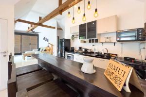 a kitchen with a wooden counter top in a room at Pool Villa Bangrak, 2 mins to beach!!!! in Koh Samui 