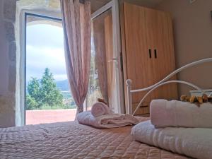 a bedroom with a bed with a large window at Rocky Mountain Villa in Ramní