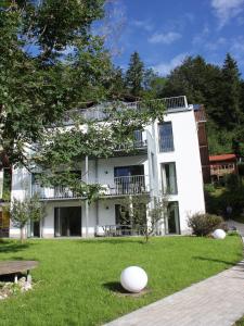 a large white building with a grassy yard in front of it at Haus Elise in Füssen