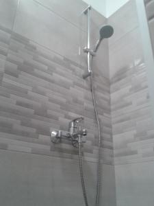 a shower with a shower head in a bathroom at SEA VIEW in Zadar