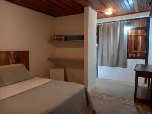 a bedroom with a bed and a window with a window at Pousada Serra Morena in Serra do Cipo +60 photos