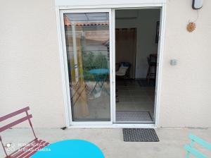 a sliding glass door of a house with a patio at Studio Gujan-mestras in Gujan-Mestras