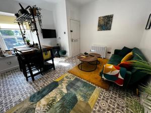 a living room with a couch and a table at Cozy and modern flat in the heart of Hawick in Hawick