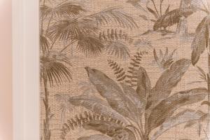 a wallpaper with palm trees and plants on a wall at Le Dimore di Puglia - Palazzo Ladogana in Monopoli