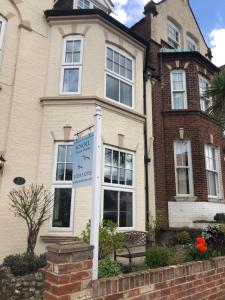 a house with a sign in front of it at Knoll Guest House in Cromer