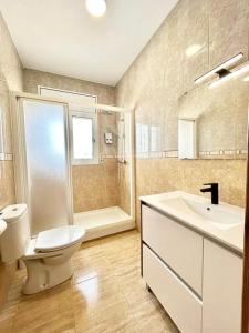 a bathroom with a toilet and a sink and a shower at Villa Escaleta Costa dorada piscina salina y privada,barbacoa in Les tres Cales