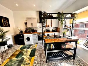 a kitchen with a counter and a stove top oven at Cozy and modern flat in the heart of Hawick in Hawick
