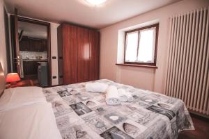 Postel nebo postele na pokoji v ubytování Residence Aquila - Bilo Punta Valfredda
