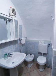 a bathroom with a white sink and a toilet at La cortese - By Ligooria in Pietra Ligure