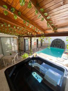 a large swimming pool in a house with a table and a tablektop at Hotel Colores Boutique in Medellín