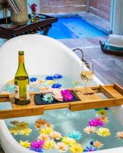 a table with a bottle of wine and a glass at Casa Loba Suite 3 with private pool and tub in Rincon