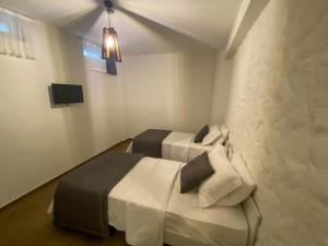 a room with two beds and a tv in it at NO 35 Alaçatı in Alacati