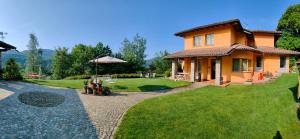 B&B Villa Claudia في لافينا بونتي تريسا: منزل مع حديقة وحديقة