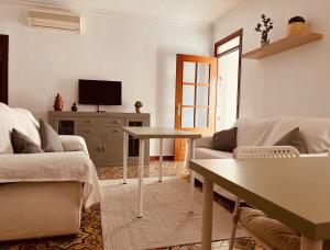 a living room with a couch and a table at NOVO Apartahotel & Restaurante in Las Cabezas de San Juan