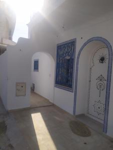 an empty room with a door and a window at Dar Fatma in Hammamet