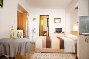 a hotel room with a bed and a table at Studio LUKA in Rovinj