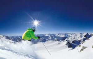 a person is skiing down a snow covered mountain at Sporthotel Cristall in Fulpmes