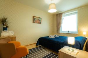 a hotel room with a bed and a window at Poilsis klonyje in Druskininkai