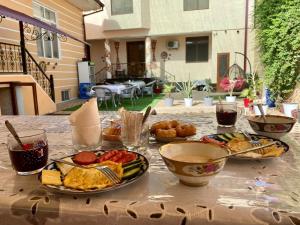 a table with plates of food on top of it at Imran&Bek in Samarkand