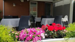 a patio with tables and flowers in a pot at B&B Terrazza Belfiore in Florence