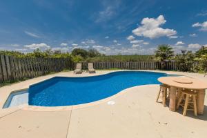 a swimming pool with a table and a table and chairs at 4 the 9 in Virginia Beach