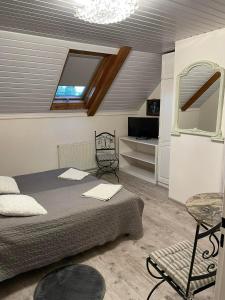 a bedroom with a bed and a window and a chair at Motel Królowej Jadwigi in Sandomierz