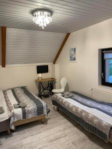 a bedroom with two beds and a desk with a computer at Motel Królowej Jadwigi in Sandomierz
