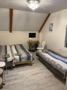 a bedroom with two beds and a desk with a computer at Motel Królowej Jadwigi in Sandomierz