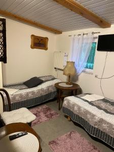 a room with two beds and a table with a lamp at Motel Królowej Jadwigi in Sandomierz
