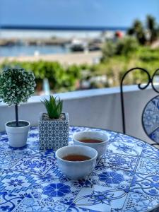 a table with two bowls of coffee on a blue and white table cloth at Seaview apartment in Tsoútsouros