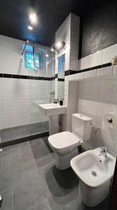 a bathroom with a toilet and a sink at Sunrise apartment in Bistriţa