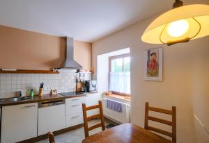 a kitchen with a table and chairs and a window at Chalupa Novákova vyhlídka in Ždírec