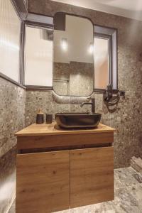 a bathroom with a sink and a mirror at Centrally Stylish Suite by Acropolis in Athens