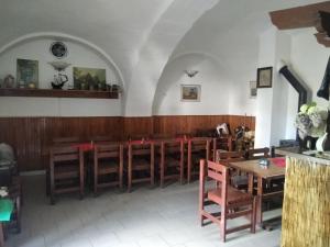a church with a row of wooden tables and chairs at Penzion U Jezu Dobronice in Dobronice
