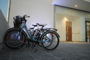 two bikes parked in front of a building at Amphora Hotel & Suites in Paphos