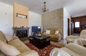 a living room with a couch and a fireplace at SunShine Villa Paphos in Nicosia