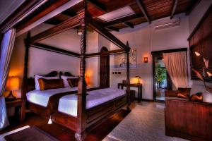 a bedroom with a canopy bed in a room at Bali Retreat Aruba -2 Pools,Cinema,Yoga,Cave in Noord +47 photos